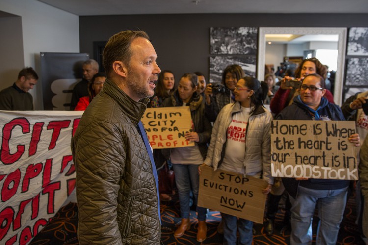 Photo of a man talking to protesters