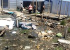 Photo of demolished shacks in mud