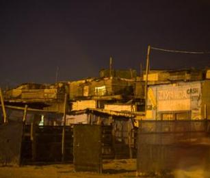 Khayelitsha lit by streetlights at night. Khayelitsha lit by streetlights at night.