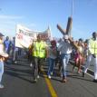 Pastor Xola Skosana of the Way of Life Church bearing a cross leads a march through Khayelitsha. Photo by Bulelani Ngovi. Pastor Xola Skosana of the Way of Life Church bearing a cross leads a march through Khayelitsha. Photo by Bulelani Ngovi.
