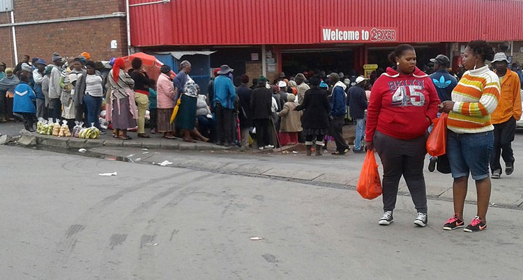 Photo of people queuing for social grants