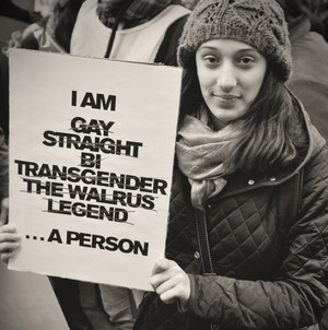 Photo of person holding poster saying I am Gay Straight Bi Transgender The Walrus Legend ... A Person'