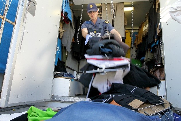 Photo of police searching a stall