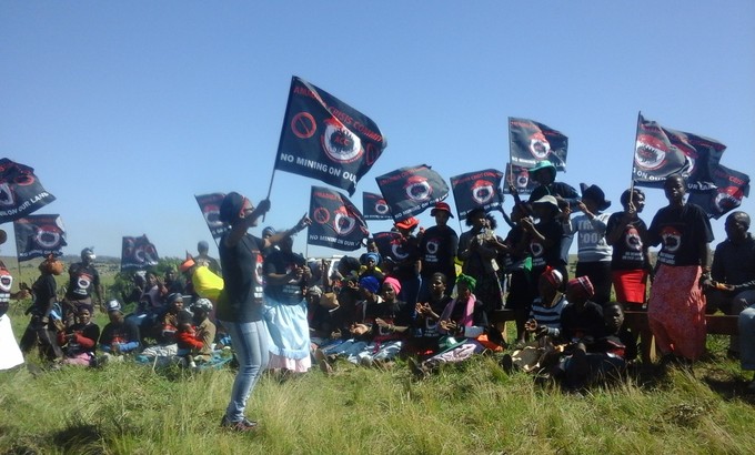 Photo of protesters with flags saying No mining on our land