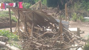 Photo of demolished shack, washing on the line