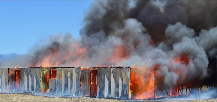 Photo of shacks on fire