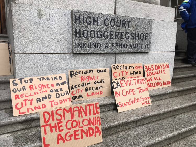 Photo of court building with protest posters outside