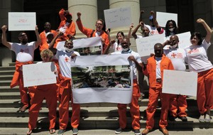Photo of protesters in orange overalls