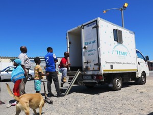 Photo of people waiting at mobile animal clinic.