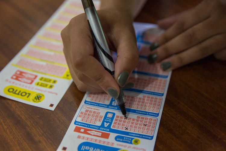 Photo of person filling out Lottery ticket