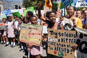 Grade 11 pupil Zenile Ngcame of Masiphumelele High School, raises her fist during a protest for climate change outside Parliament in Cape Town.