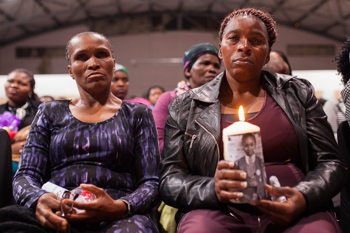 Photo of two women holding a candle