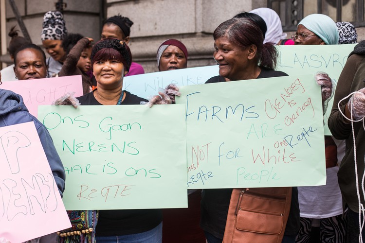 Photo of two women holding up picketing posters