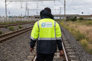 Photo of a PRASA employee walking on the train tracks