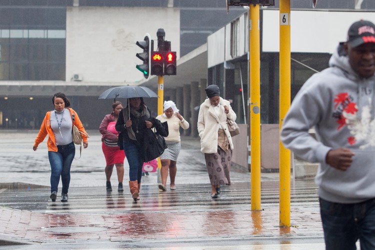 Photo of people walking in rain
