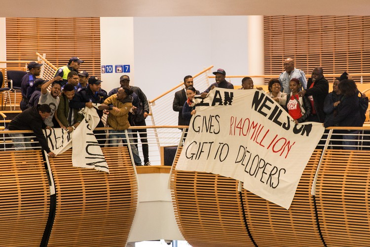 Photo of protesters at city council meeting