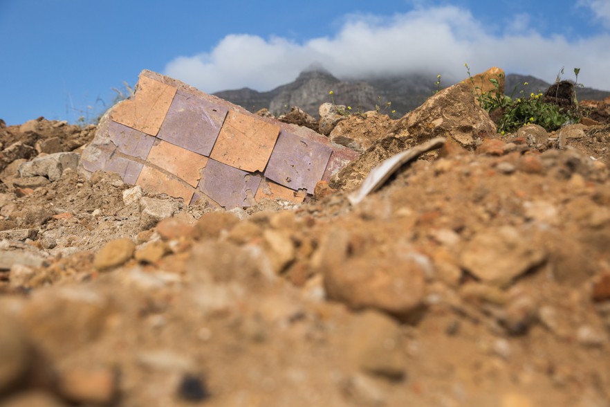 Tiles from homes previously demolished by the apartheid regime lie in the rubble.
