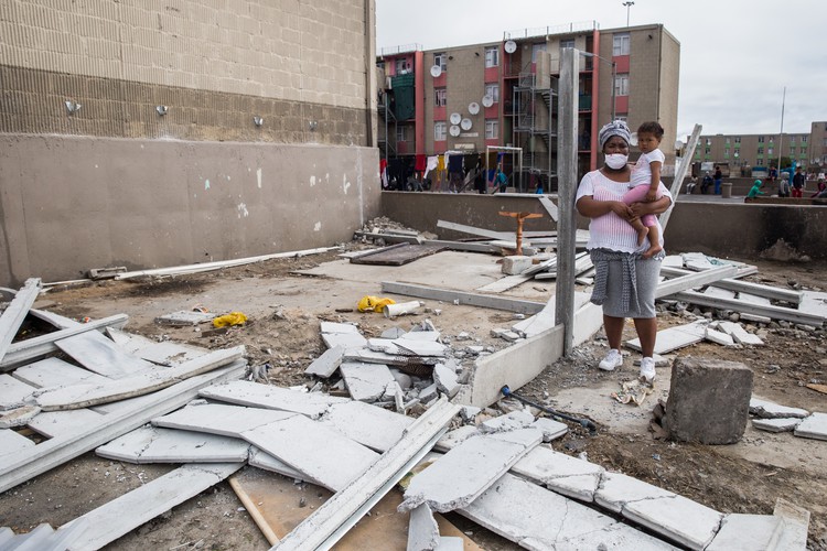 Tiffany Turner and her two-year-old daughter Tamar stand outside their demolished home in Elsies River. Photo: Ashraf Hendricks