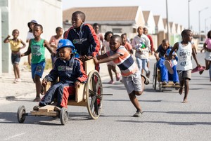 Children race go-karts in township