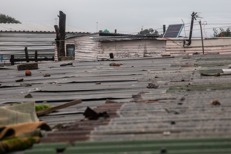 Photo of shacks and a solar panel