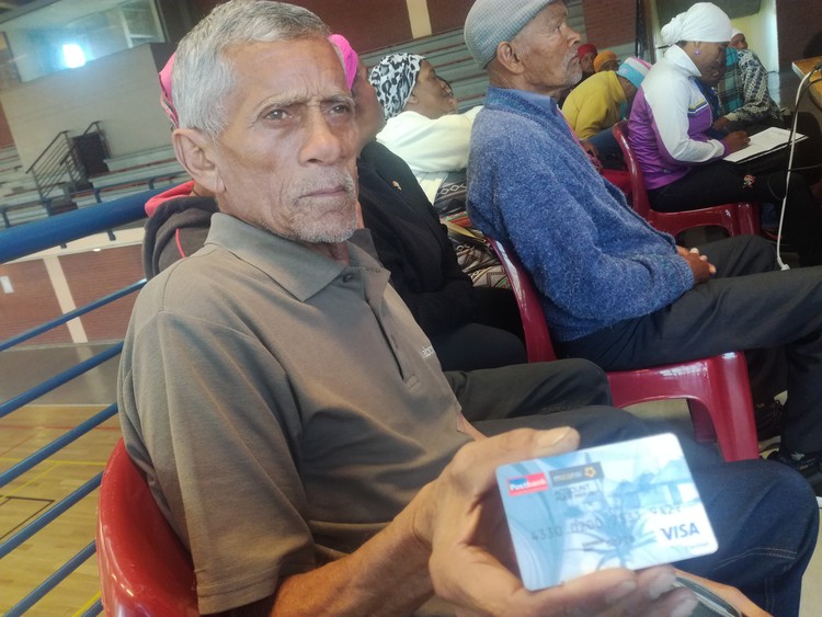 Photo of man holding Post Office card