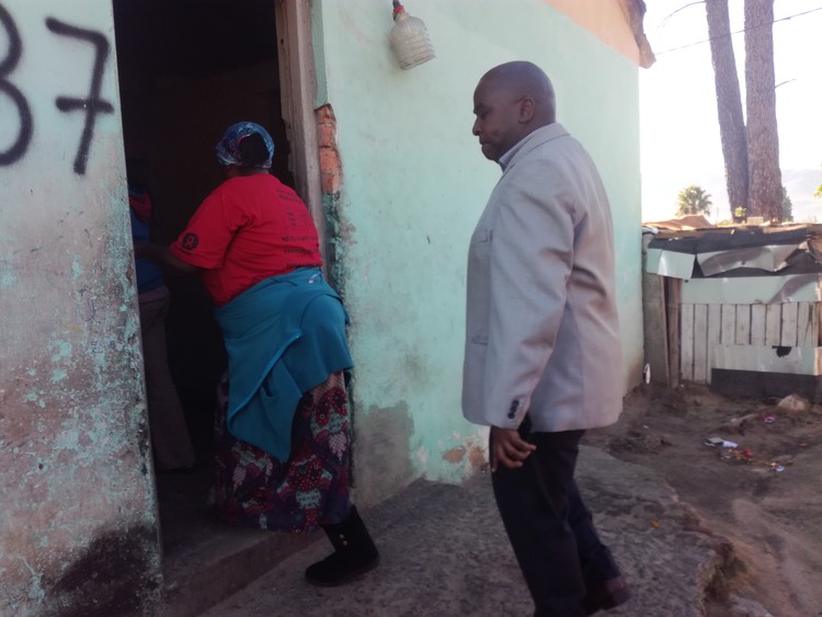 Photo of woman showing man a house