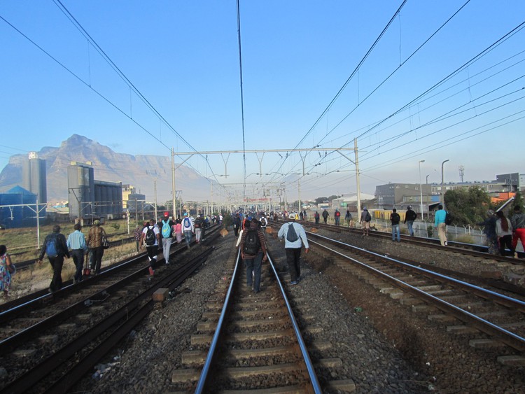 Photo of people walking on railway tracks