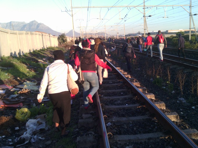 Photo of people walking on train tracks