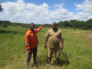 Photo of two men showing an open field