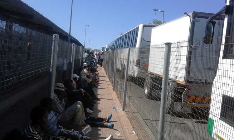 Photo of people sitting in a line