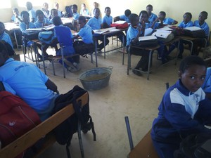 Photo of classroom with bucket for leaks