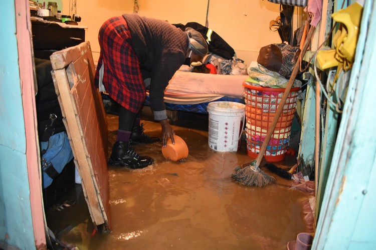 Ntombizodwa Duba from Khunqu informal settlement in Khayelitsha scoops water out of her shack. Photo: Buziwe Nocuze