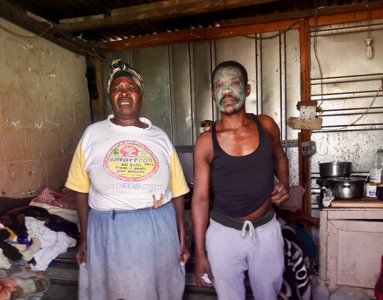 Photo of two people in a shack