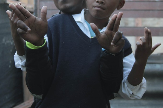 Photo of two people doing gang salute