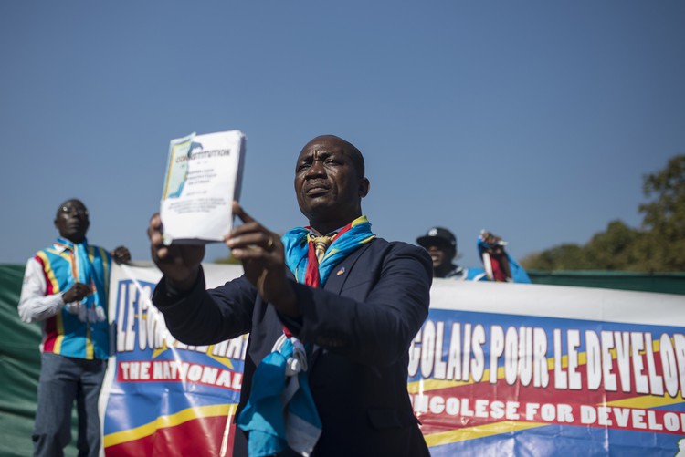 Photo of man holding up DRC constitution