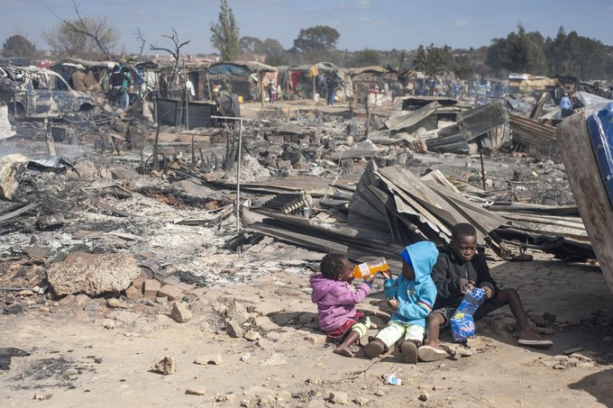 Photo of children in a burnt out area