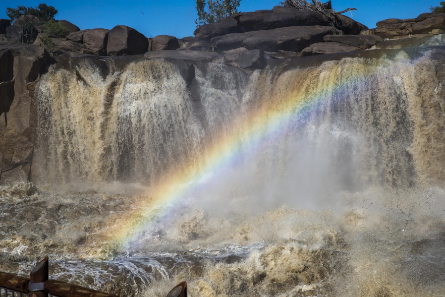A rainbow forms in the dense spray at Augrabies Falls