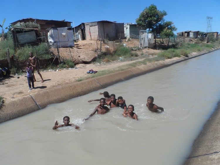 Photo of children swimming in canal