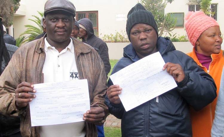 Photo of two men with documents