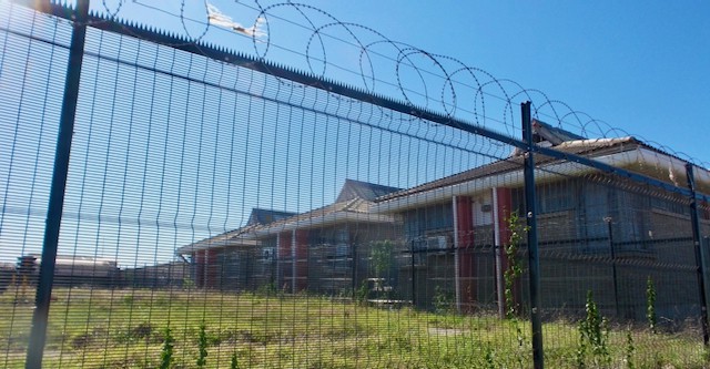 Photo of a building behind a fence