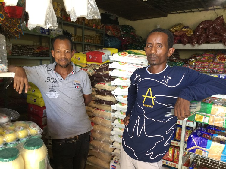 Photo of two men in small shop