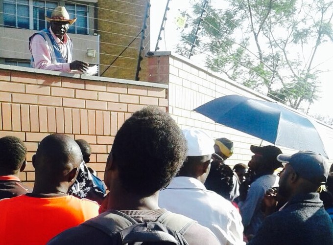 Photo of man looking down at asylum seekers