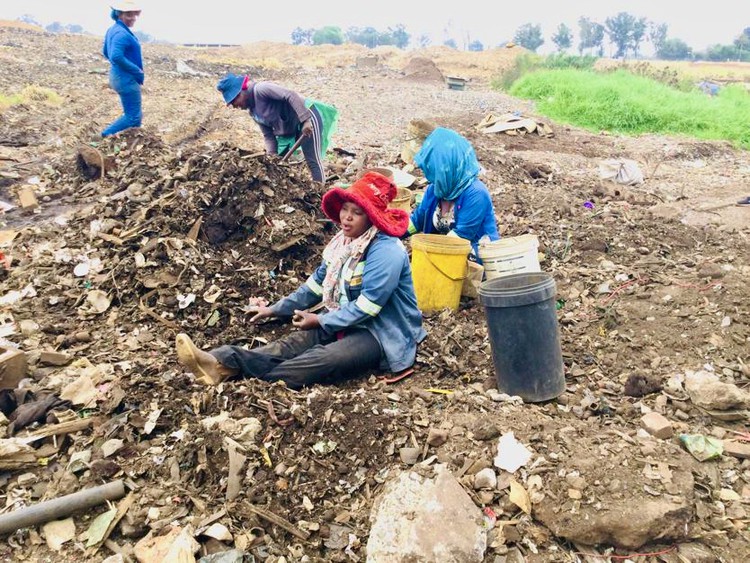 Photo of women on a dump site