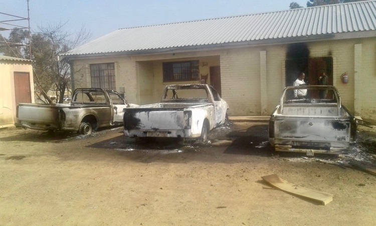 Photo of three burnt out cars