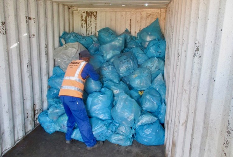 Photo of a man inside a rubbish container