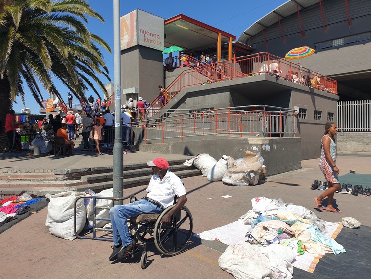 Photo of man in wheelchair in front of station steps