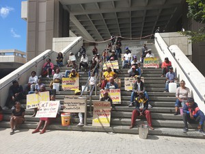 Photo of residents on the steps of the civic centre with placards