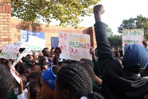 School students marching with banners