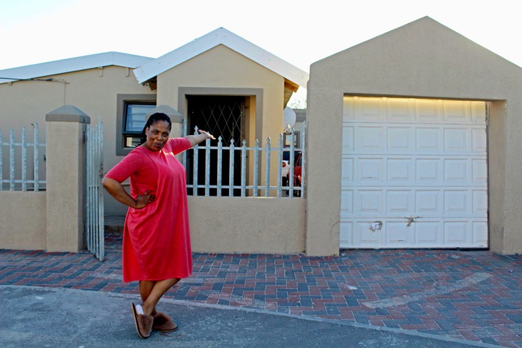 Photo of a woman outside her house