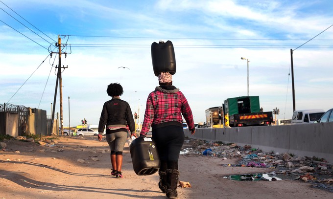 Photo of women walking with containers